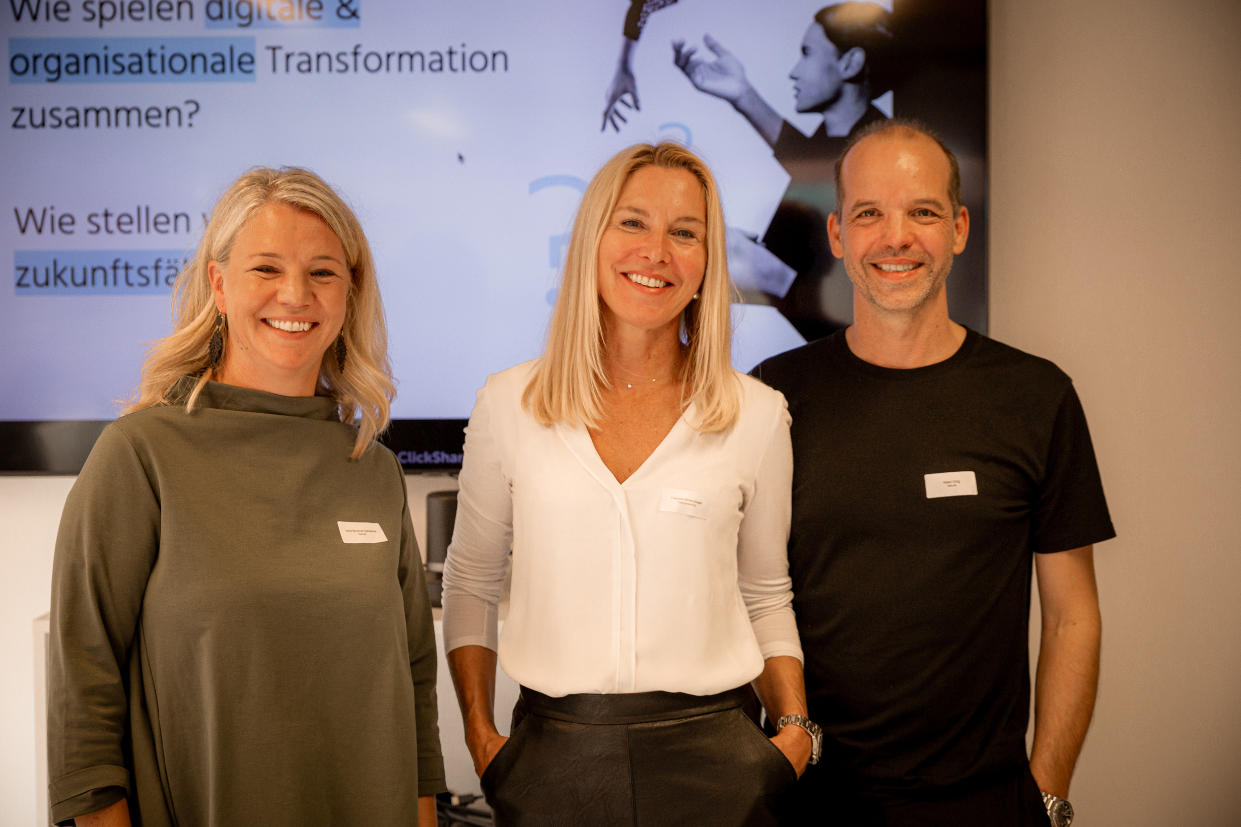 Irene Bouchal-Gahleitner, Claudia Wintersberger, and Albert Ortig smiling at the camera during Netural’s AI Impulse Breakfast.