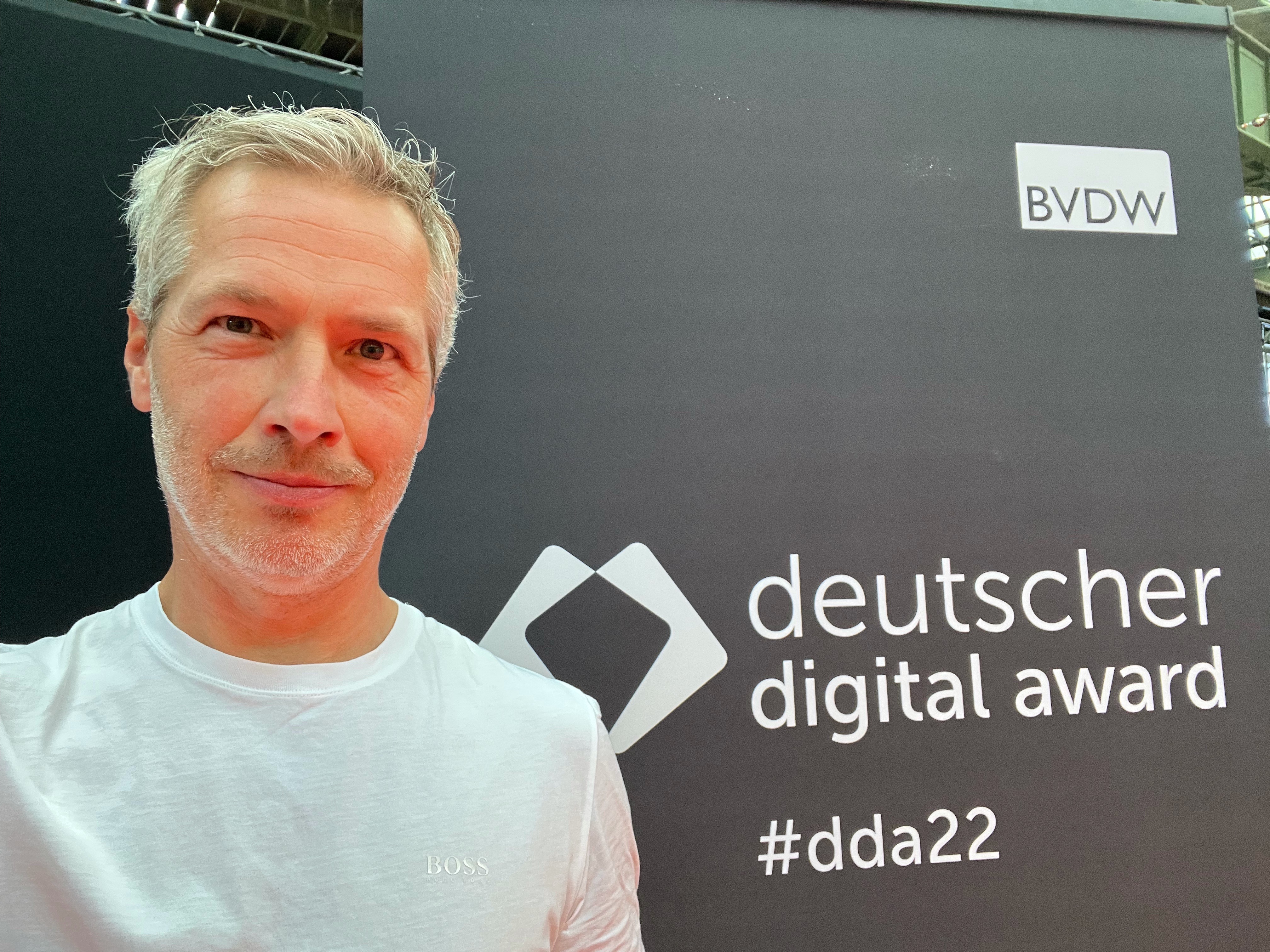 Stephan Lechner in front of a wall with the “deutscher digital award” logo and hashtag #dda22.