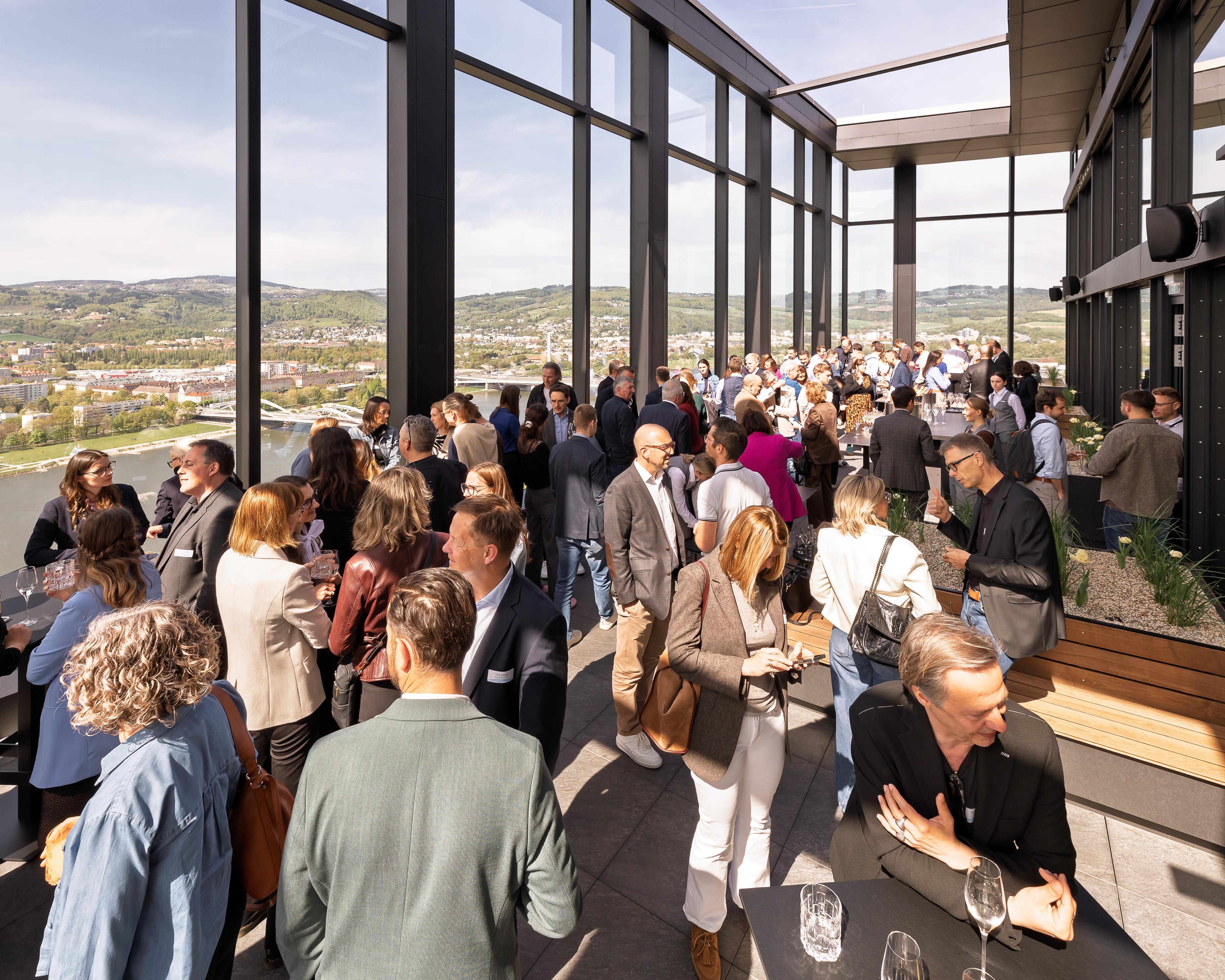 Guests at the top floor of the building with a nice view over Linz